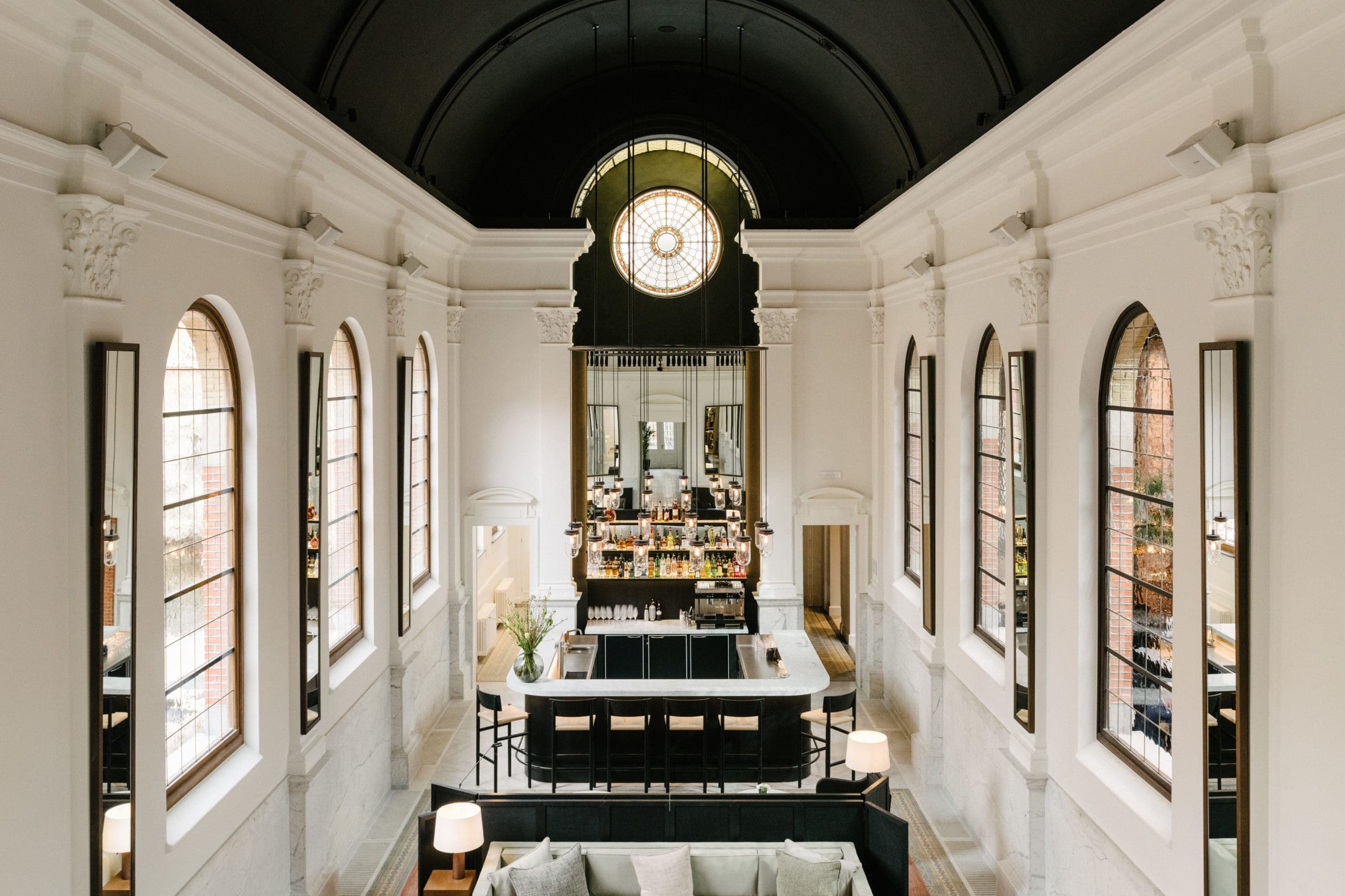 A tall chapel interior in brick with a long counter set beneath the windows