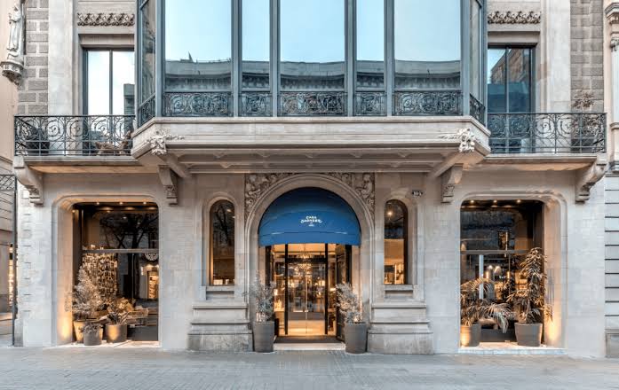 Iron balconies and shuttered windows on a gridded Barcelona street front