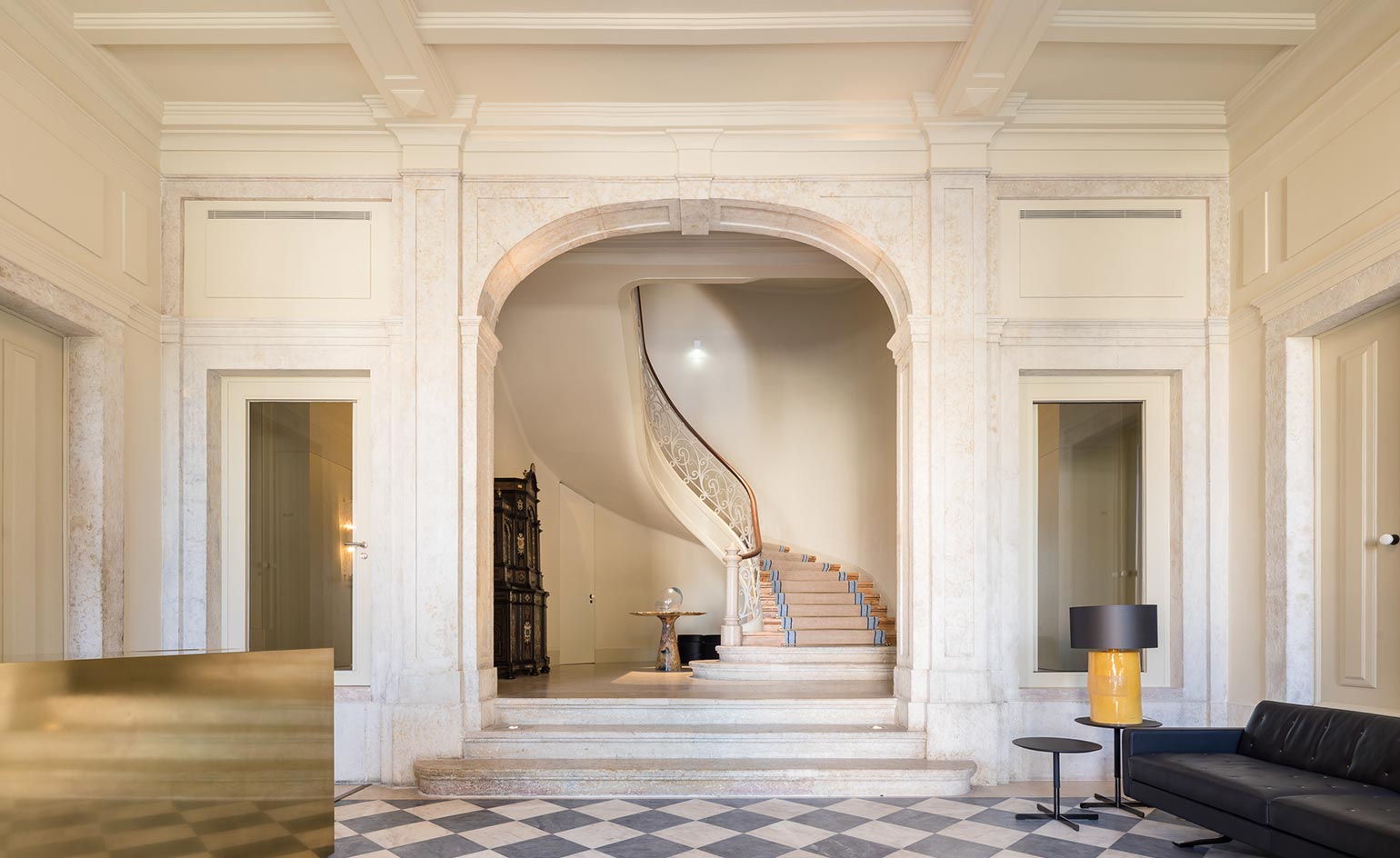 A stone stair with a painted ceiling above it inside an old Lisbon palace