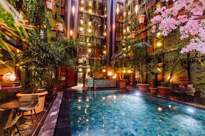 Galleries of a covered courtyard with plants trailing between balconies