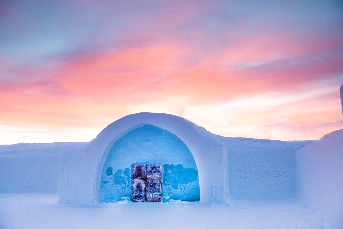 A snow structure on a frozen northern plain under low blue light